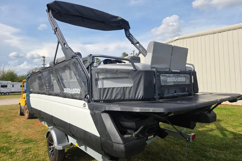 Slide: The Image of 2024 Sea-Doo Switch Cruise 21 pontoon boat on trailer, parked outdoors. - 5