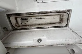Slide: The Image of 2019 Striper 230 DC boat compartment with visible wear and dirt. - 10