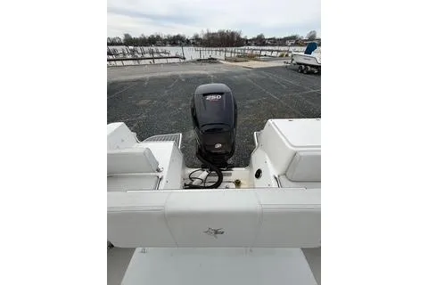 Slide: The Image of 2019 Striper 230 DC boat with powerful outboard motor in a parking area. - 11
