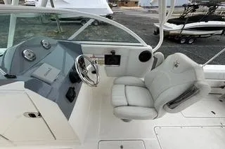 Slide: The Image of 2019 Striper 230 DC boat interior with steering wheel and comfortable seating. - 13