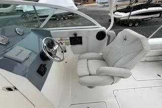 Slide: The Image of 2019 Striper 230 DC boat interior with steering wheel and cushioned captain's chair. - 14