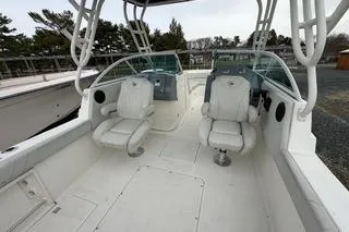 Slide: The Image of 2019 Striper 230 DC boat interior with dual captain chairs and spacious deck. - 16