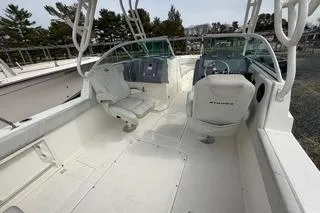 Slide: The Image of 2019 Striper 230 DC boat interior with dual consoles and seating. - 17