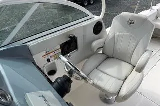 Slide: The Image of 2019 Striper 230 DC boat cockpit with steering wheel and comfortable captain's chair. - 18