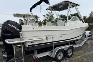 Slide: The Image of 2019 Striper 230 DC boat on trailer with Mercury outboard motor. - 2