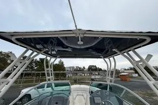 Slide: The Image of 2019 Striper 230 DC boat with T-top, viewed from the bow. - 23