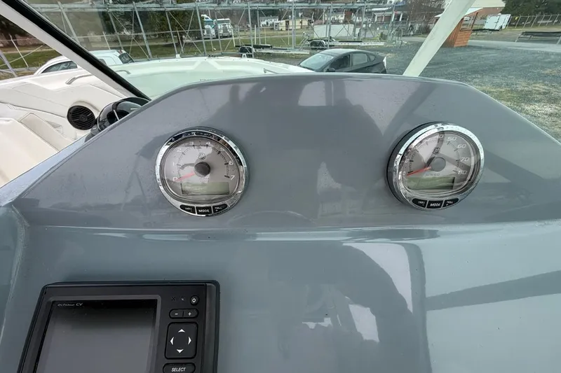 Slide: The Image of Dashboard of a 2019 Striper 230 DC boat with gauges and controls. - 25