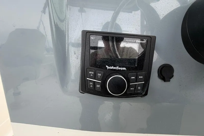 Slide: The Image of Rockford Fosgate audio system on 2019 Striper 230 DC boat dashboard. - 27