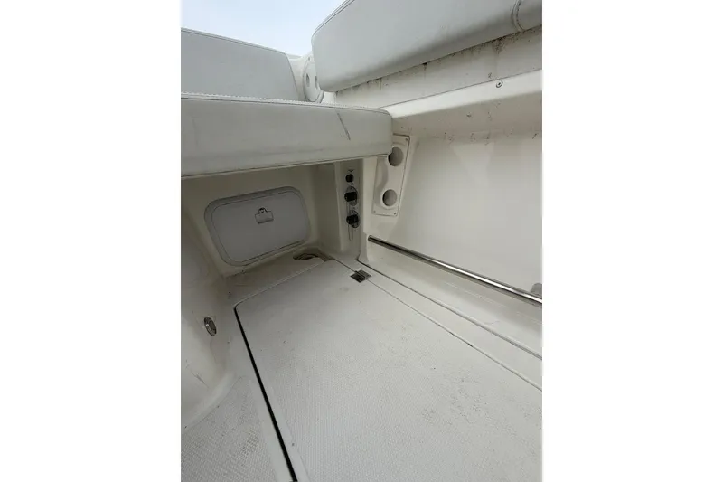 Slide: The Image of 2019 Striper 230 DC boat interior with storage compartment and seating area. - 28