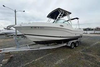 Slide: The Image of 2019 Striper 230 DC boat on a trailer, parked outdoors. - 3