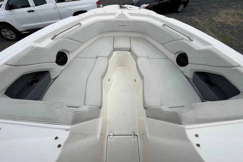 Slide: The Image of 2019 Striper 230 DC boat interior with white seating and cup holders. - 31
