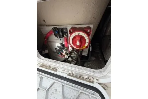Slide: The Image of 2019 Striper 230 DC boat battery compartment with red switch and wiring. - 34