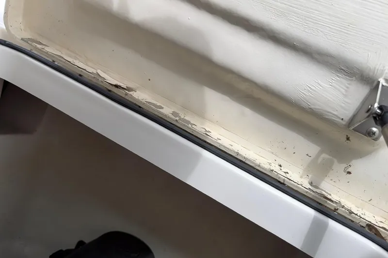 Slide: The Image of Close-up of 2019 Striper 230 DC boat showing wear and peeling paint. - 37