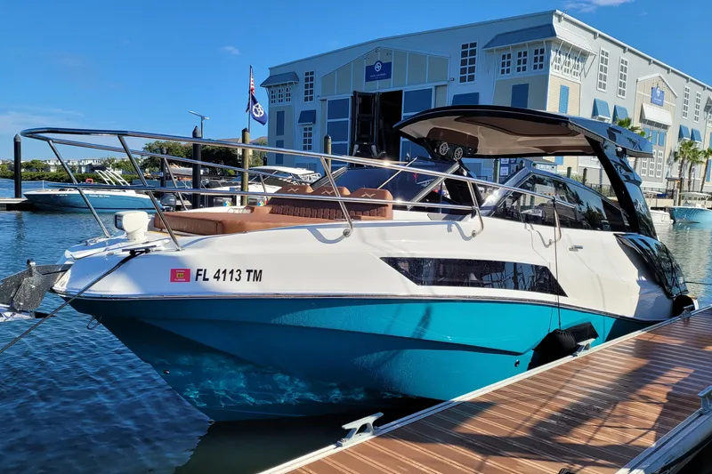 The Image of 2023 NX Boats NX340 docked at marina, showcasing sleek design and modern features. - 1