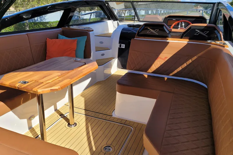Slide: The Image of Luxurious interior of 2023 NX Boats NX340 with elegant seating and wooden table. - 11