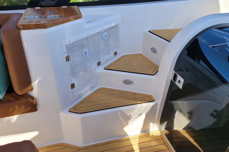 Slide: The Image of Interior of 2023 NX Boats NX340 featuring wooden steps and seating area. - 12