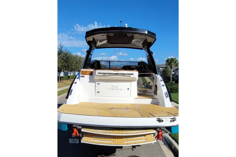 Slide: The Image of 2023 NX Boats NX340 luxury boat with open deck and sleek design. - 15