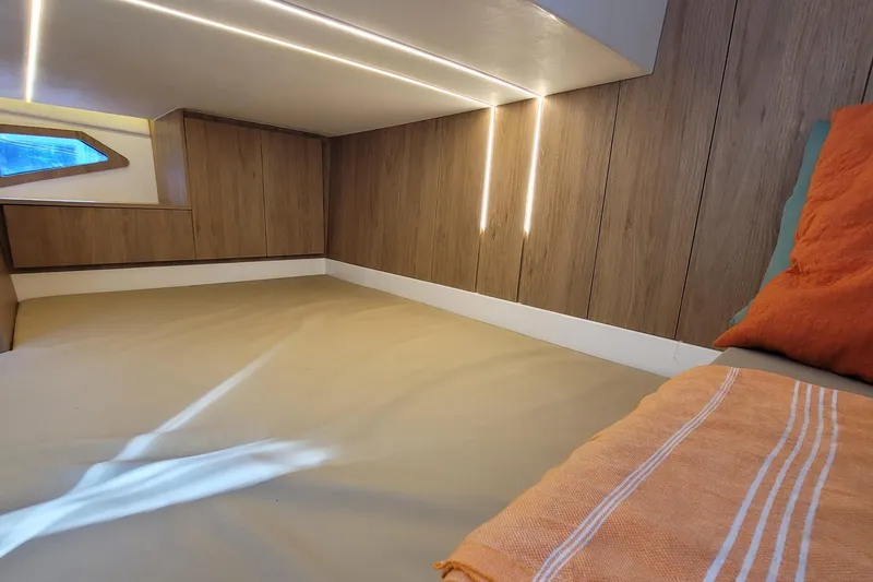 Slide: The Image of Luxurious interior cabin of 2023 NX Boats NX340 with modern wood paneling and ambient lighting. - 21