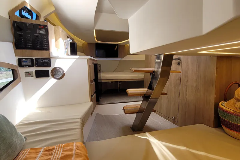 Slide: The Image of Interior of 2023 NX Boats NX340, featuring modern design, cozy seating, and wooden accents. - 24