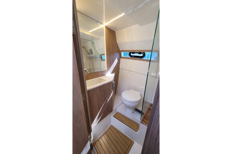 Slide: The Image of 2023 NX Boats NX340 bathroom with modern design, featuring wood accents and compact layout. - 25