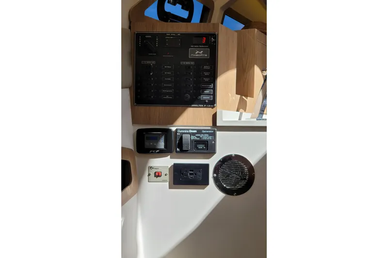 Slide: The Image of Control panel of 2023 NX Boats NX340, featuring various switches and displays. - 27