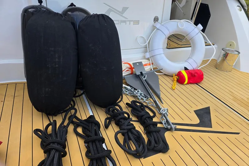 Slide: The Image of Deck of 2023 NX Boats NX340 with boating equipment: fenders, ropes, anchor, and lifebuoy. - 28