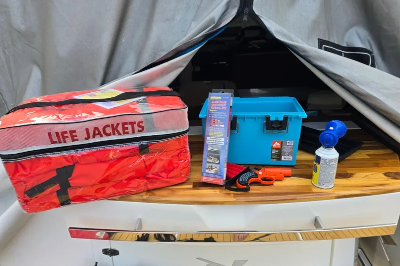 Slide: The Image of Safety equipment on NX Boats NX340, 2023 model, including life jackets and emergency tools. - 29