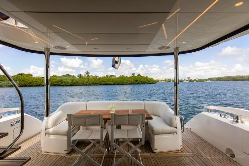 Slide: The Image of Luxurious Sunseeker Manhattan 68 yacht deck with seating, overlooking serene waters, 2021 model. - 100