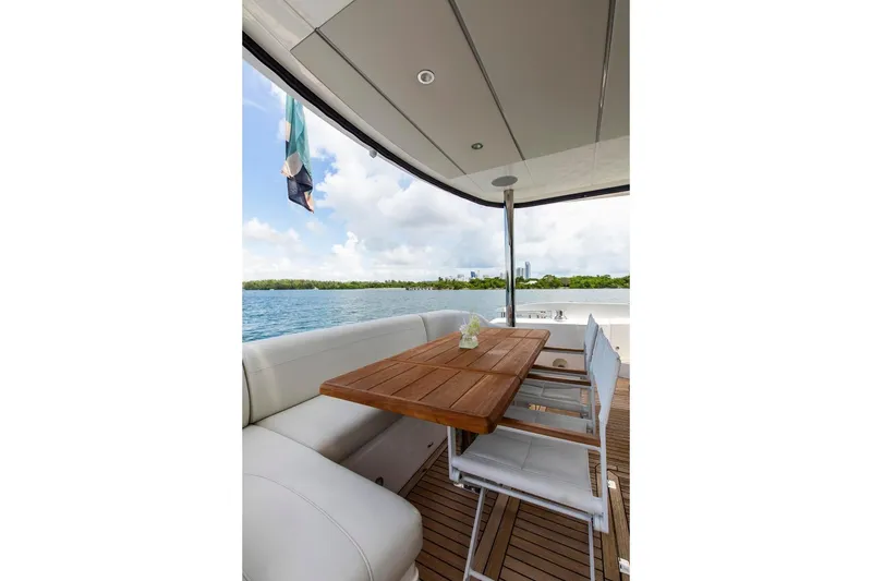 Slide: The Image of Luxurious Sunseeker Manhattan 68 yacht deck with seating and wooden table, 2021 model. - 102