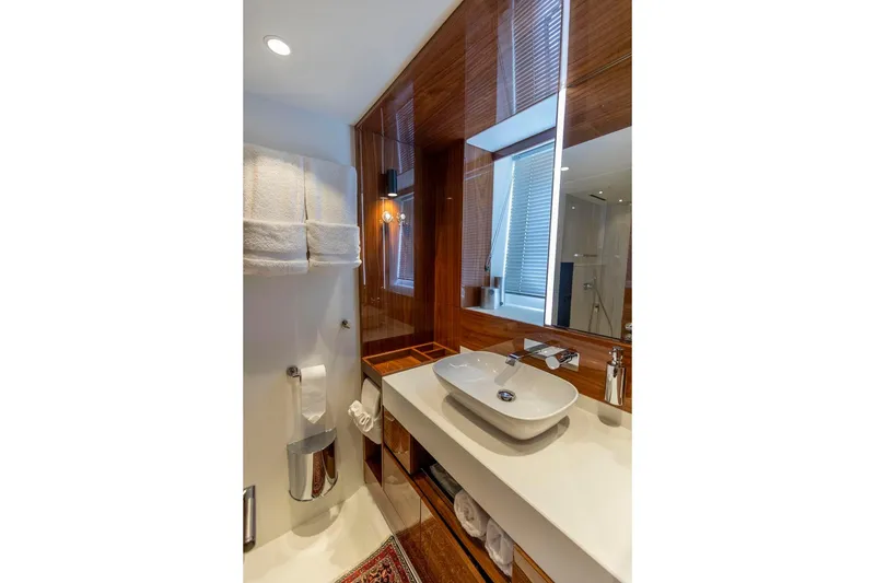 Slide: The Image of Luxurious bathroom in 2021 Sunseeker Manhattan 68 yacht, featuring modern sink and elegant wood finishes. - 11