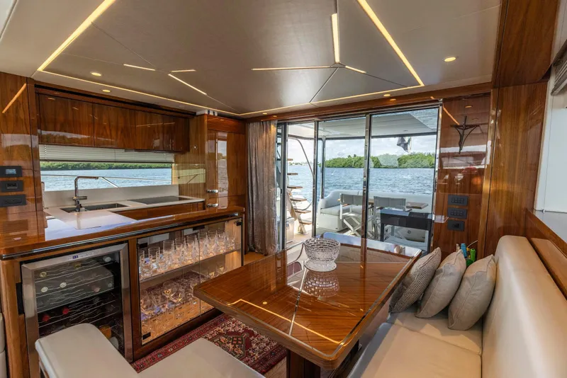 Slide: The Image of Luxurious interior of 2021 Sunseeker Manhattan 68 yacht with elegant dining area and scenic view. - 111
