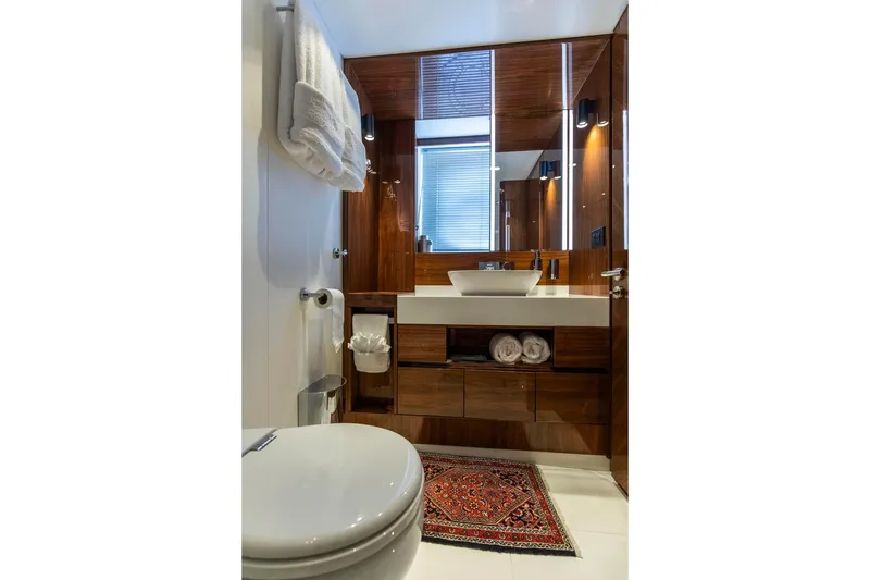 Slide: The Image of Luxurious bathroom in 2021 Sunseeker Manhattan 68 yacht, featuring elegant wood finishes and modern fixtures. - 12