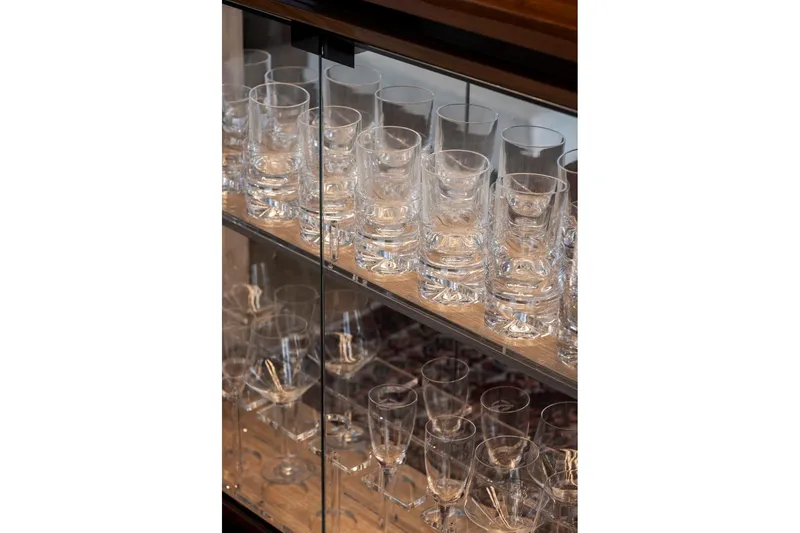 Slide: The Image of Glassware display in a cabinet aboard a 2021 Sunseeker Manhattan 68 yacht. - 122