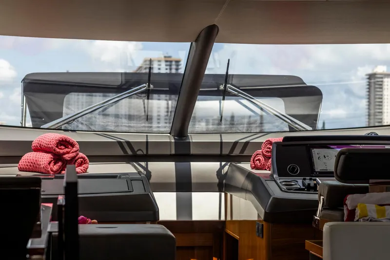 Slide: The Image of Interior view of 2021 Sunseeker Manhattan 68 yacht cockpit with red towels and modern controls. - 123