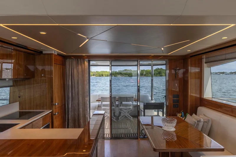 Slide: The Image of Luxurious interior of 2021 Sunseeker Manhattan 68 yacht with elegant wood finishes and waterfront view. - 125