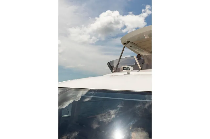 Slide: The Image of 2021 Sunseeker Manhattan 68 yacht against a cloudy sky backdrop. - 128