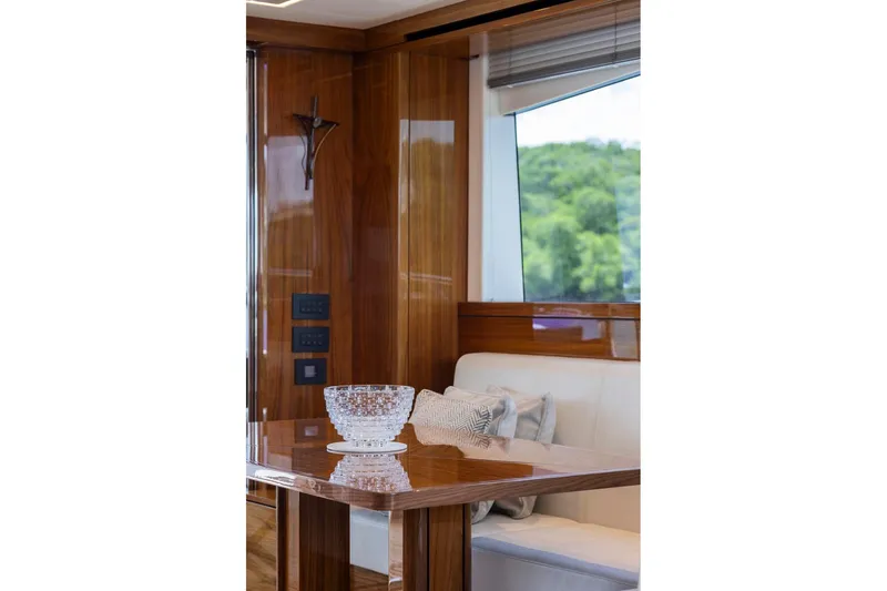 Slide: The Image of Luxurious interior of 2021 Sunseeker Manhattan 68 yacht with elegant wood finish and seating area. - 129
