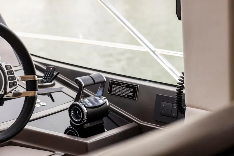 Slide: The Image of Interior helm of 2021 Sunseeker Manhattan 68 yacht, featuring modern controls and steering wheel. - 132