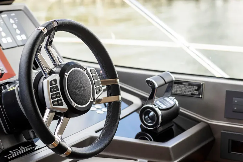 Slide: The Image of Steering wheel and controls of 2021 Sunseeker Manhattan 68 yacht cockpit. - 135