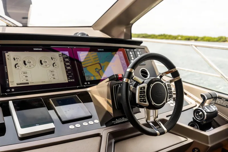 Slide: The Image of Helm of 2021 Sunseeker Manhattan 68 yacht with advanced navigation displays and controls. - 18