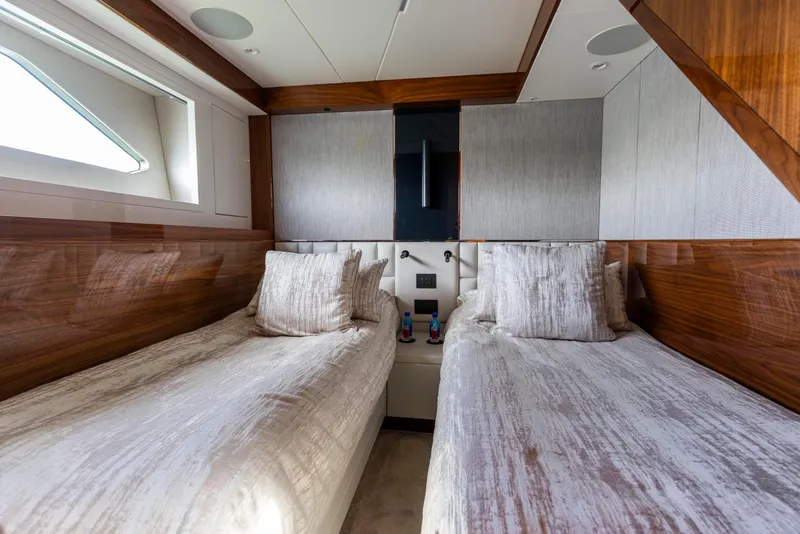 Slide: The Image of Luxurious twin cabin interior of 2021 Sunseeker Manhattan 68 yacht with elegant wood finishes. - 32