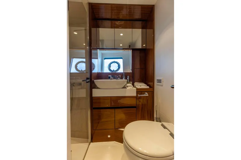 Slide: The Image of Luxurious bathroom on 2021 Sunseeker Manhattan 68 yacht with modern fixtures and wood accents. - 40