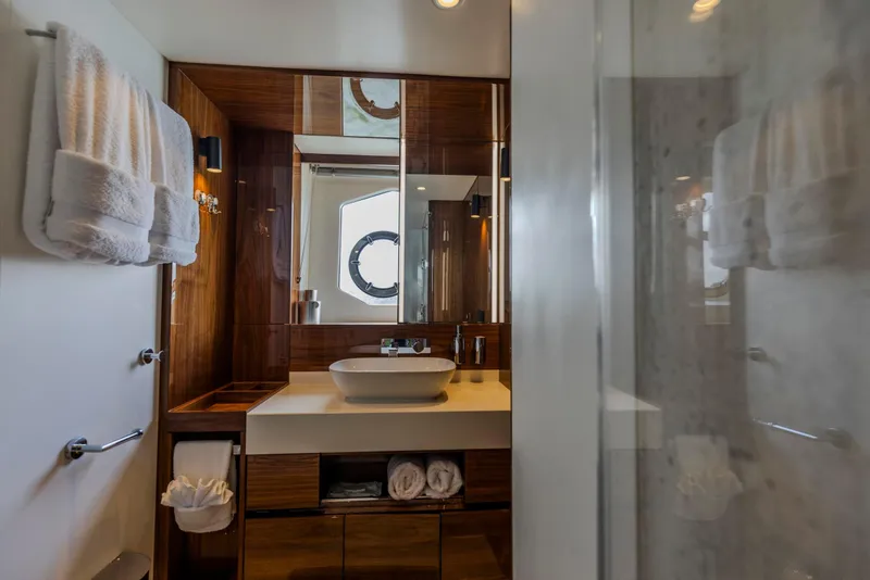 Slide: The Image of Luxurious bathroom interior on a 2021 Sunseeker Manhattan 68 yacht, featuring elegant wood finishes. - 54
