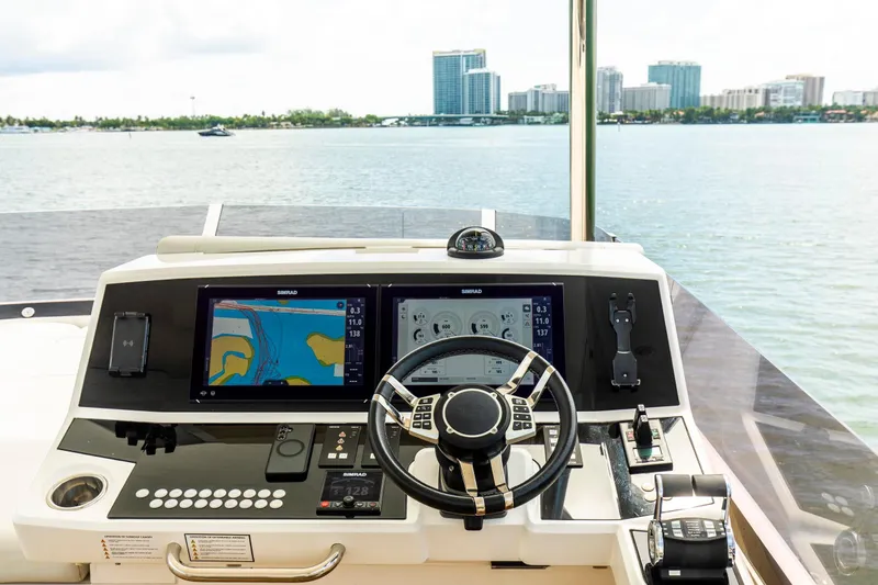 Slide: The Image of Cockpit of 2021 Sunseeker Manhattan 68 yacht with navigation screens and steering wheel. - 59
