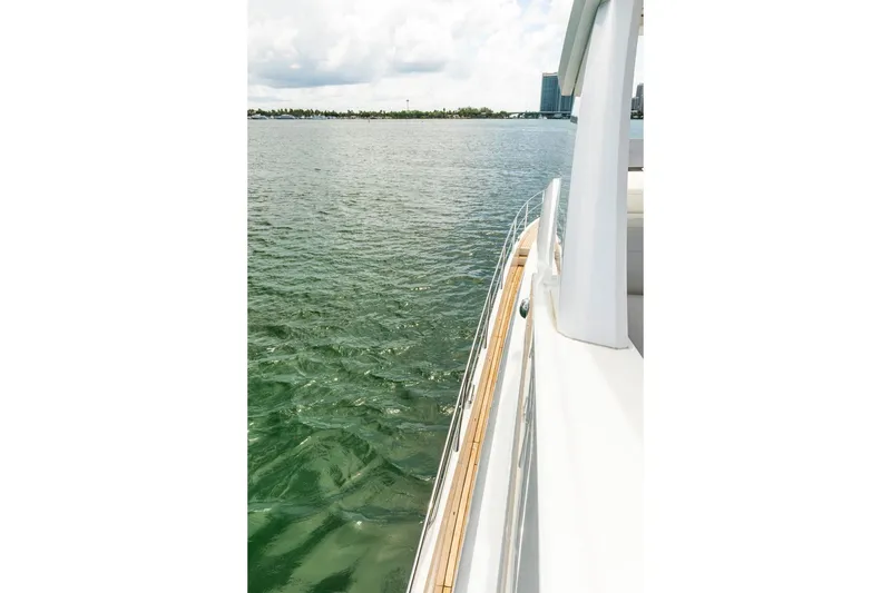 Slide: The Image of Sunseeker Manhattan 68 yacht cruising on calm waters, 2021 model. - 65