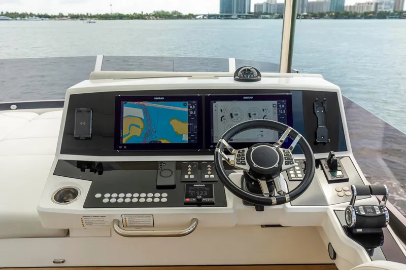 Slide: The Image of Helm of 2021 Sunseeker Manhattan 68 yacht with navigation screens and controls. - 76
