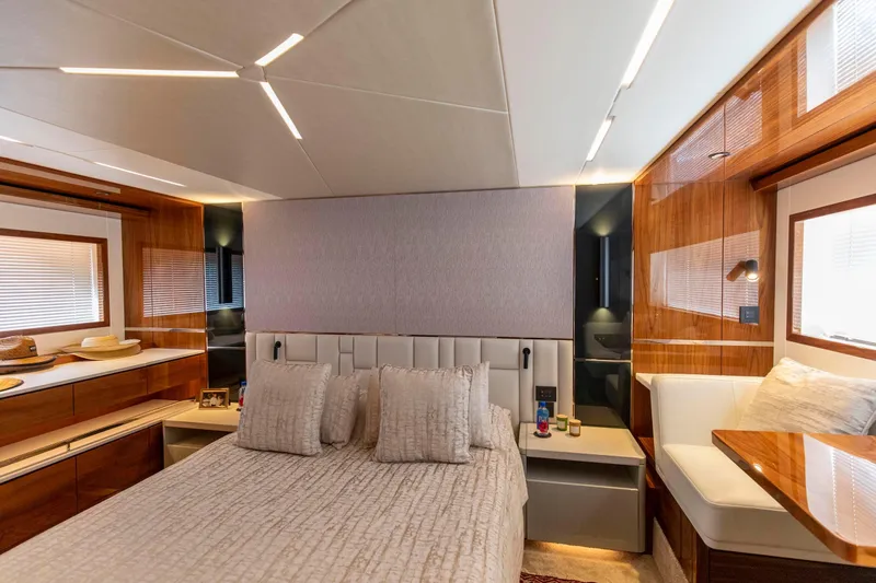 Slide: The Image of Luxurious bedroom interior of 2021 Sunseeker Manhattan 68 yacht, featuring elegant wood finishes. - 8