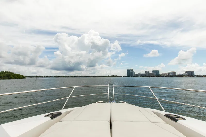 Slide: The Image of Bow view from 2021 Sunseeker Manhattan 68 yacht, overlooking city skyline and ocean. - 82