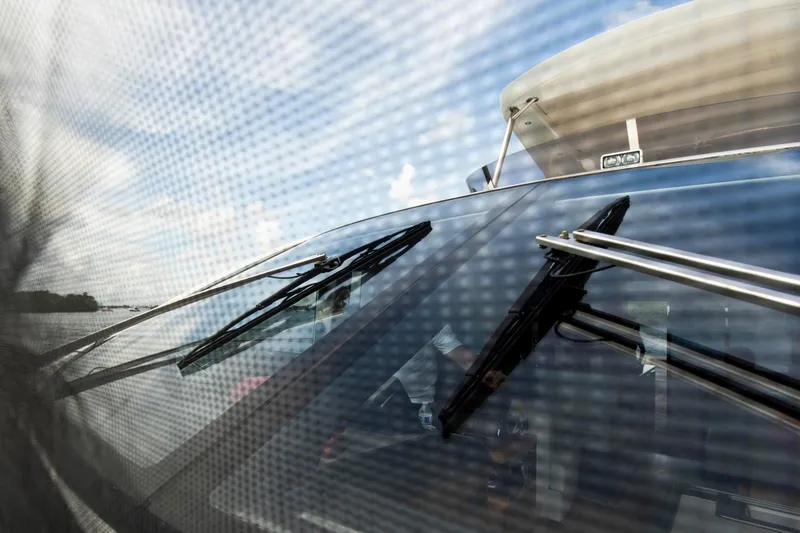 Slide: The Image of 2021 Sunseeker Manhattan 68 yacht windshield with wipers, viewed through mesh screen. - 83