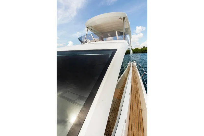 Slide: The Image of 2021 Sunseeker Manhattan 68 yacht, sleek design, wooden deck, cruising on blue water. - 87